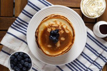 Pancakes with blueberry on a wooden table