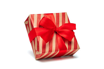 Close up shot of gift box wrapped in striped craft paper and decorated with satin ribbon bow, isolated on white background