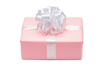 Close up shot of gift box wrapped in pastel pink paper and decorated with white satin ribbon bow, isolated on white background