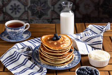 Pancakes with blueberry on a wooden table