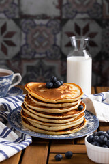 Pancakes with blueberry on a wooden table
