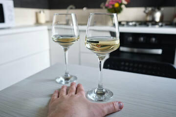 A glass of wine or champagne in the hands of a man. Tasting of alcoholic beverages. Celebrate and enjoy the moment. Glass of wine close-up
