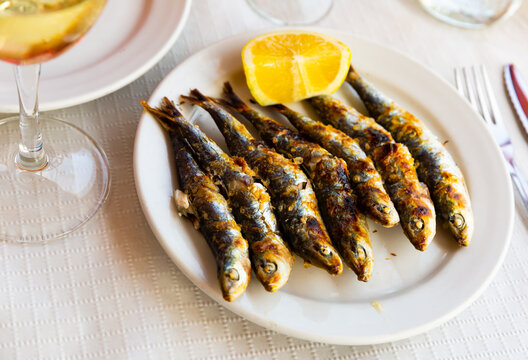 Espeto de sardinas, famous dish of Costa del Sol, charcoal grilled sardines served with slice of lemon