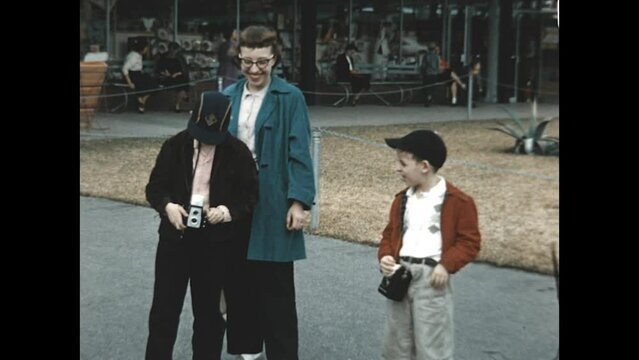Focusing the Shot 1955 - A boy focuses his camera on the camerman while his mother and brother observe in 1955. 