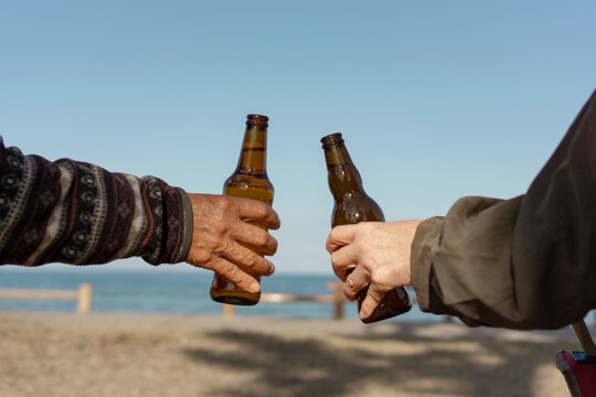 Middle aged or senior people drinking beer.  Two people toasting outdoors.  ビールを飲む中高年またはシニア仲間。屋外で乾杯する二人。
