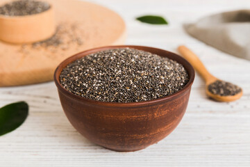 Chia seeds in bowl and spoon on colored background. Healthy Salvia hispanica in small bowl. Healthy superfood