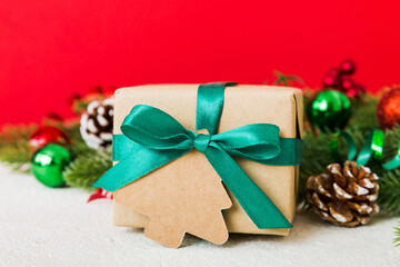 New Year Christmas mood, gift box, branches of a christmas tree, New Year decorations on a colored background