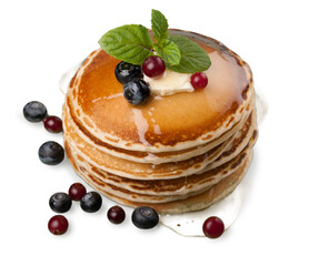 Stack of Small pancakes in syrup and berries on background
