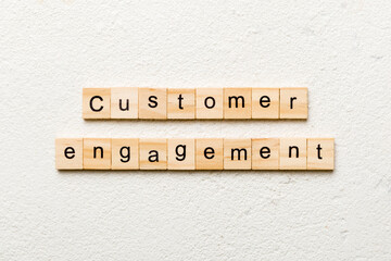 Customer engagement word written on wood block. Customer engagement text on cement table for your desing, concept