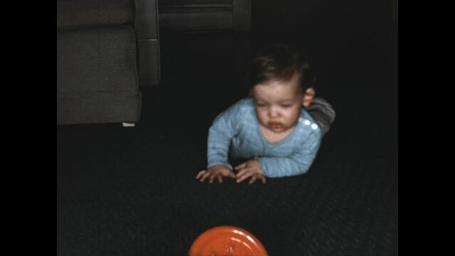 Baby Belly Crawls 1951 - A baby belly crawls across the floor to reach a toy in 1951. 