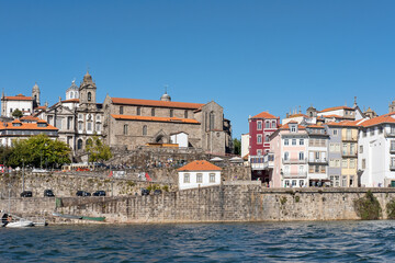 Obraz premium View of the city toward the northern bank from Douro River, eclectic urban display of various architectural styles with major cultural and historical significance in Porto, Portugal