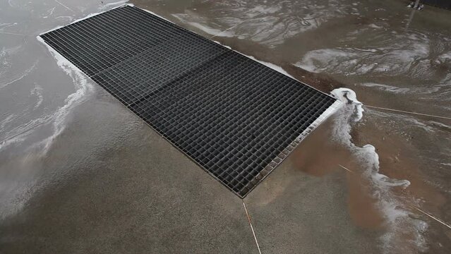 The washer washes the dirt from the floor down the drain at the car wash. Car shampoo drains into the drainage system.