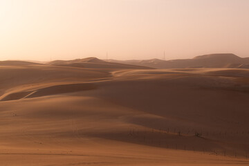 Fototapeta na wymiar Sand dunes in the desert at sunset