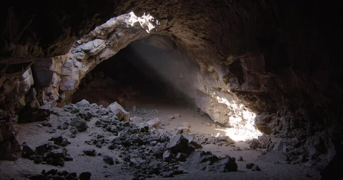 Dust Swirls In Ray Of Light Shining Down From Ceiling Of Collapsing Cave