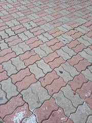 close up textured red brick walkway.
