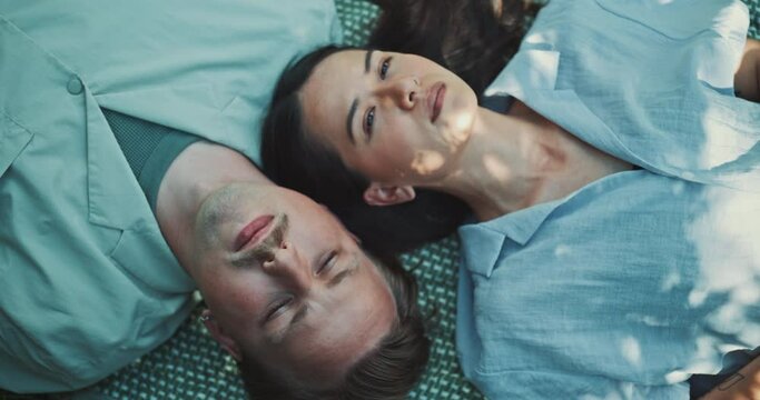 Two young women using sound bowl to practice meditation in the nature