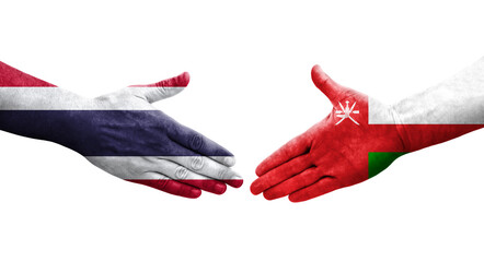 Handshake between Oman and Thailand flags painted on hands, isolated transparent image.