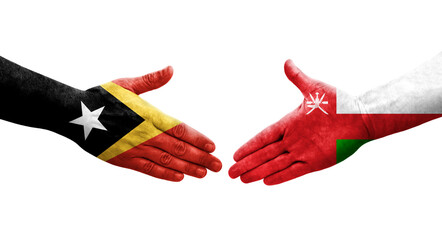 Handshake between Oman and Timor Leste flags painted on hands, isolated transparent image.