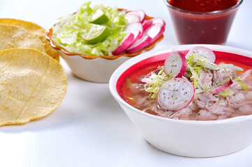 Traditional Mexican soup Pozole accompanied with chicken and pork meat