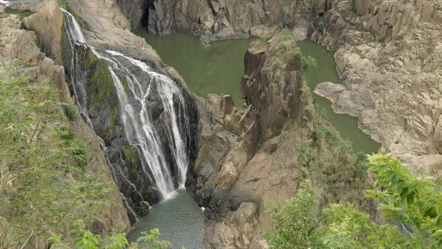 a zoom in on the base of barron falls during the dry season at kuranda in north qld, australia
