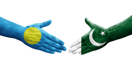 Handshake between Pakistan and Palau flags painted on hands, isolated transparent image.