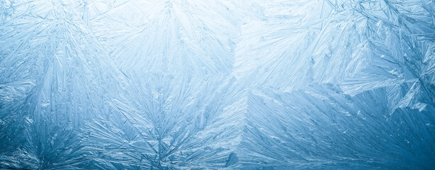 Winter frost patterns on glass. Ice crystals or cold winter background. - 545011734