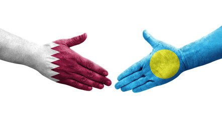 Handshake between Palau and Qatar flags painted on hands, isolated transparent image.