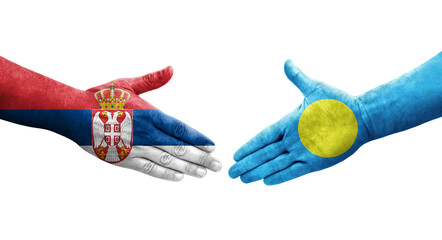 Handshake between Palau and Serbia flags painted on hands, isolated transparent image.