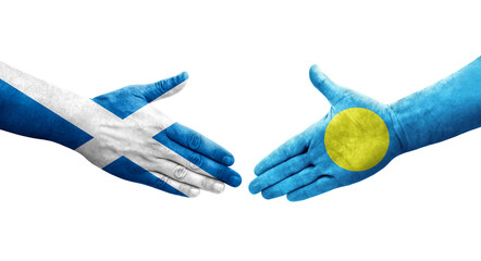 Handshake between Palau and Scotland flags painted on hands, isolated transparent image.