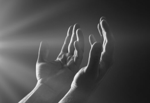 Hand of prayer person worship with light