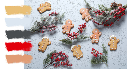 Tasty Christmas cookies with red berries and green branches on grey background. Different color patterns