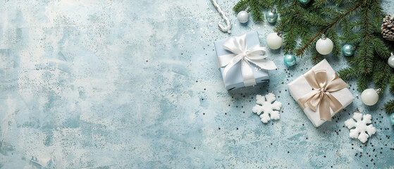 Composition with fir branches, Christmas gifts and decorations on light blue background with space for text
