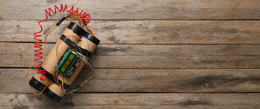 Bomb with timer on wooden background with space for text