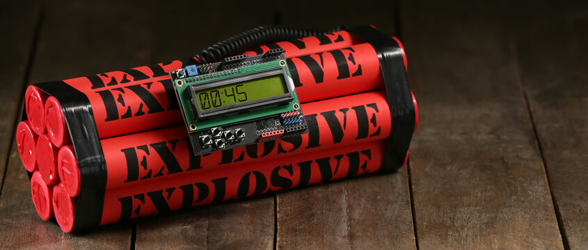 Bomb with timer on wooden background
