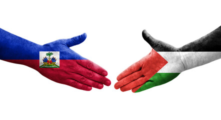 Handshake between Palestine and Haiti flags painted on hands, isolated transparent image.