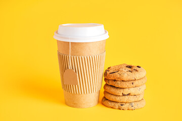 Paper cup of tea and tasty cookies on color background