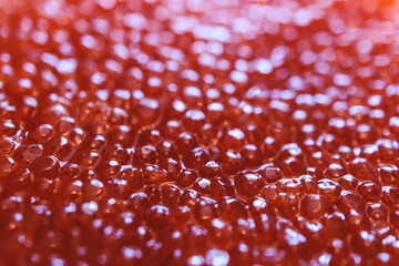 Red caviar close-up macro texture,  salted red caviar on a seafood production, packaging and...