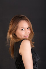 Fototapeta premium portrait of smiling girl on black background