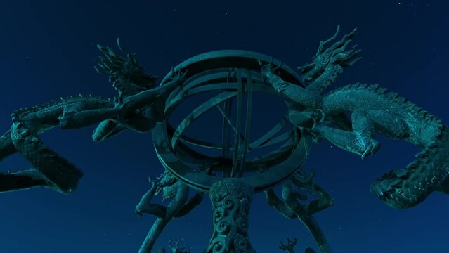 Under the night sky, low-angle shot of the sculpture of the seismograph invented by Zhang Heng of the Eastern Han Dynasty