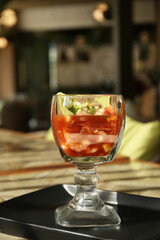 Delicious campechana cocktail with fresh ingredients on table