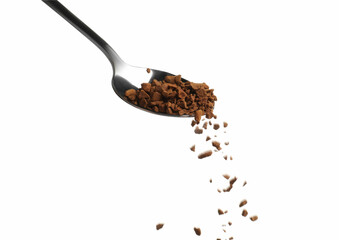 Pouring aromatic instant coffee from spoon on white background