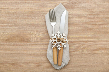 Stylish cutlery for Christmas celebration on wooden background