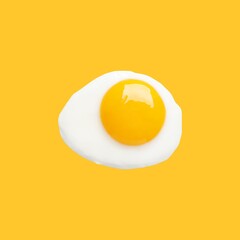Tasty fried chicken egg on yellow background, top view
