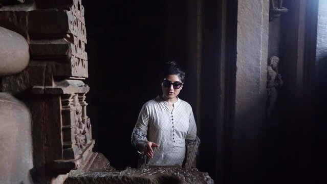 Indian Woman Admiring The Ornate Stone Carvings Inside Khajuraho Temple In Madhya Pradesh, India. - Slow Motion