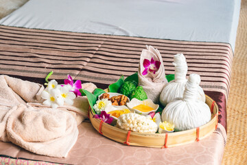 Fototapeta na wymiar Herbs ingredients in bamboo basket for override the salt pot compress top view, Thai traditional medicine hot compress therapy. Thai herbal for health massage alternative medicine.