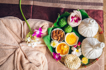 Herbs ingredients in bamboo basket for override the salt pot compress top view, Thai traditional medicine hot compress therapy. Thai herbal for health massage alternative medicine.