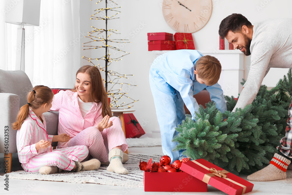 Poster Happy parents and their little children with Christmas tree at home