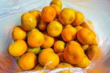 dozens of oranges in a plastic bag