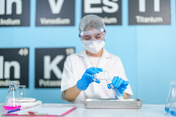 Modern medical research laboratories Beautiful female scientist wearing protective goggles mixes chemicals in test tubes in laboratory biochemical samples, an advanced science laboratory for medicine