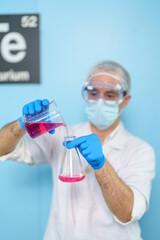 Modern medical research laboratories Beautiful male scientist wearing protective goggles mixes chemicals in test tubes in laboratory biochemical samples, an advanced science laboratory for medicine.